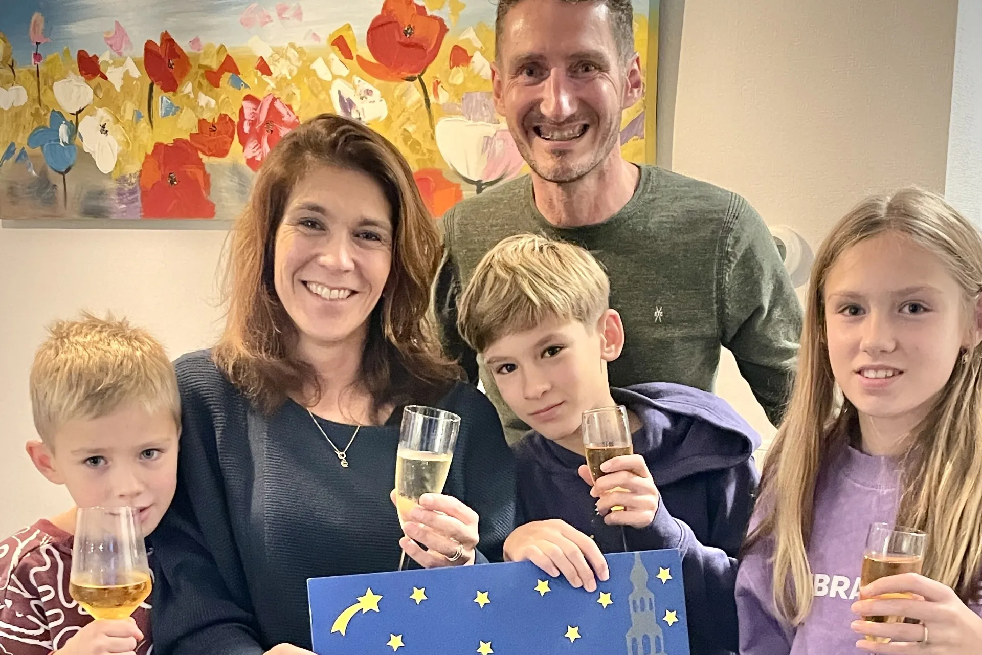 Winnaar schrijfwedstrijd Janneke Verbaarschot met haar gezin aan de bubbels