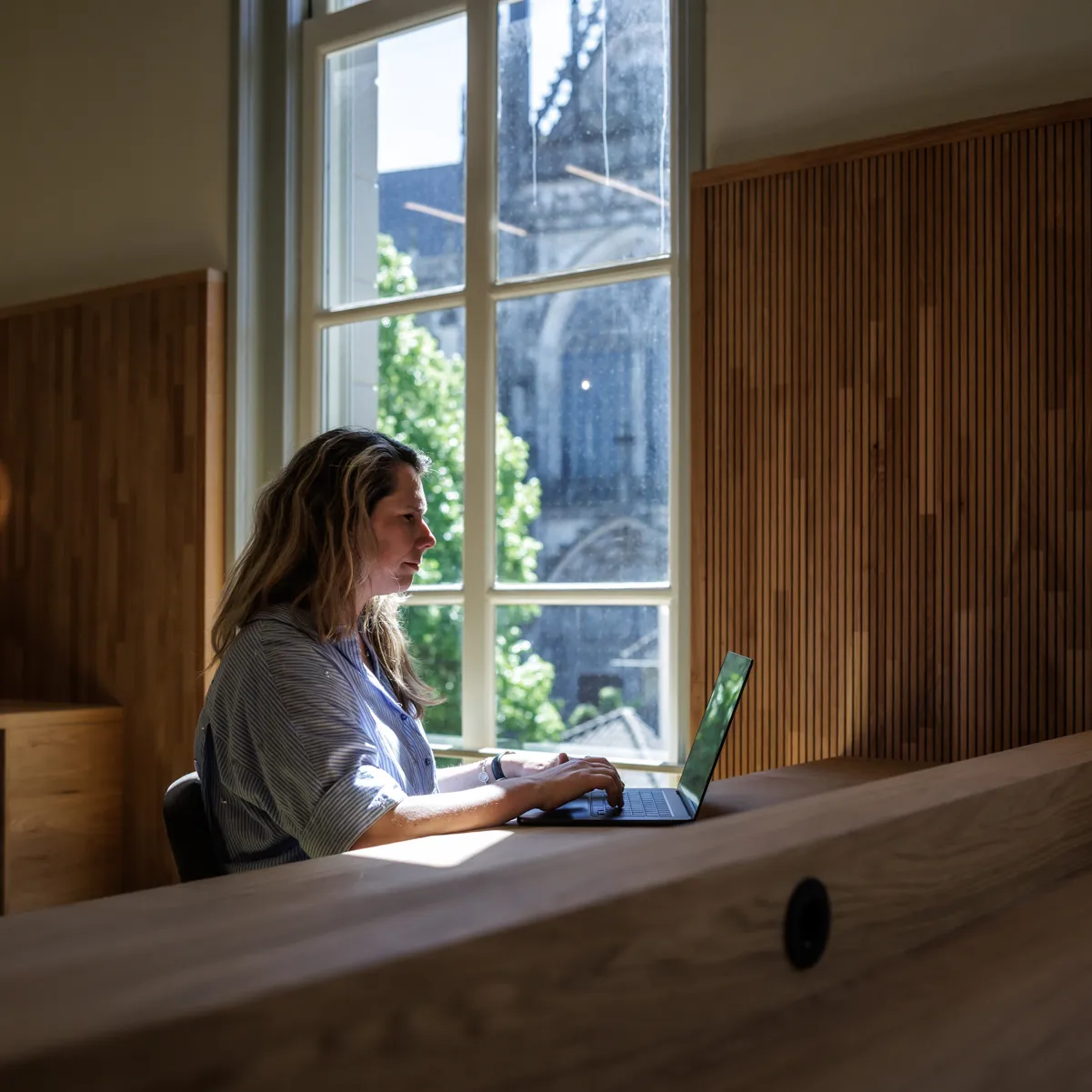 vrouw met laptop en uitzicht op Sint-Jan